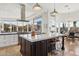 Bright kitchen with white countertops, island seating, stainless steel appliances, and desert views at 10951 E Mirasol Cir, Scottsdale, AZ 85255