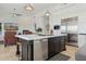 Elegant kitchen island with modern appliances, breakfast bar, and views of the open living space at 10951 E Mirasol Cir, Scottsdale, AZ 85255