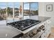 Chef's kitchen featuring a professional-grade gas cooktop and scenic outdoor views at 10951 E Mirasol Cir, Scottsdale, AZ 85255