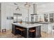 Spacious kitchen island with white countertops, barstool seating, and stainless steel appliances at 10951 E Mirasol Cir, Scottsdale, AZ 85255