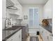 This stylish laundry room features modern appliances, ample storage and a bright window at 10951 E Mirasol Cir, Scottsdale, AZ 85255