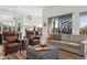 Open-concept living room with comfortable seating, desert views, and adjacent dining area at 10951 E Mirasol Cir, Scottsdale, AZ 85255
