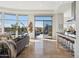 Bright living room featuring modern decor, large windows, and access to the outdoor pool area at 10951 E Mirasol Cir, Scottsdale, AZ 85255