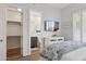 This main bedroom features a view of the bathroom and closet, a mounted television, and white shutters at 10951 E Mirasol Cir, Scottsdale, AZ 85255