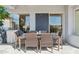 Covered patio area featuring a wicker dining set and tile flooring, perfect for outdoor meals and relaxation at 10951 E Mirasol Cir, Scottsdale, AZ 85255