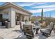 A cozy backyard patio features comfortable seating, complemented by desert landscaping and mountain views at 10951 E Mirasol Cir, Scottsdale, AZ 85255