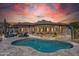 Outdoor pool area featuring desert landscaping and an expansive view of the home with colorful sky at 10951 E Mirasol Cir, Scottsdale, AZ 85255