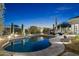 Backyard pool featuring desert landscaping, ambient lighting, and tranquil water at 10951 E Mirasol Cir, Scottsdale, AZ 85255