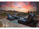 Inviting pool area features lounge chairs, mountain views, desert landscaping, and a serene sunset at 10951 E Mirasol Cir, Scottsdale, AZ 85255