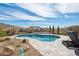 Backyard pool surrounded by desert landscaping, offering a serene retreat with scenic mountain views at 10951 E Mirasol Cir, Scottsdale, AZ 85255