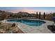 Beautiful pool with scenic views of the desert landscape and mountains at sunset at 10951 E Mirasol Cir, Scottsdale, AZ 85255