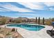 Backyard pool surrounded by lush desert landscaping, offering a serene retreat with a mountain backdrop at 10951 E Mirasol Cir, Scottsdale, AZ 85255