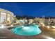 Backyard pool area featuring desert landscaping, ambient lighting, and mountain views at 10951 E Mirasol Cir, Scottsdale, AZ 85255