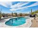 Backyard pool surrounded by desert landscaping, offering a serene retreat with scenic mountain views at 10951 E Mirasol Cir, Scottsdale, AZ 85255