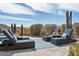 Relaxing pool area featuring comfortable lounge chairs, desert landscaping, and scenic mountain views at 10951 E Mirasol Cir, Scottsdale, AZ 85255
