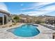 Backyard pool surrounded by lush desert landscaping, offering a serene retreat with a mountain backdrop at 10951 E Mirasol Cir, Scottsdale, AZ 85255