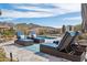 Relaxing pool area featuring comfortable lounge chairs, desert landscaping, and scenic mountain views at 10951 E Mirasol Cir, Scottsdale, AZ 85255