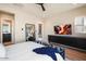 Cozy bedroom showcasing a ceiling fan, large TV, and comfortable sitting area at 12315 E Black Rock Rd, Scottsdale, AZ 85255
