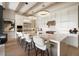 Modern, white kitchen with a large island, stainless steel appliances, and elegant lighting at 12315 E Black Rock Rd, Scottsdale, AZ 85255