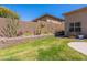 Backyard with garden beds filled with desert foliage and a grass yard with a block wall at 12770 N 145Th Way, Scottsdale, AZ 85259
