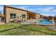 A refreshing pool with a grassy yard and patio furniture with mountain views at 12770 N 145Th Way, Scottsdale, AZ 85259