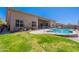 Spacious backyard with a pool, lush lawn, and patio, ideal for outdoor living at 12770 N 145Th Way, Scottsdale, AZ 85259