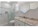 Well-lit bathroom with granite countertops and a beautifully tiled glass shower at 12770 N 145Th Way, Scottsdale, AZ 85259