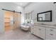 Bathroom featuring a soaking tub, granite countertops, and a sliding barn door at 12770 N 145Th Way, Scottsdale, AZ 85259