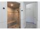 Modern shower features a glass door, built-in bench, and neutral tile, connecting to the adjacent room at 12770 N 145Th Way, Scottsdale, AZ 85259