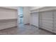 Spacious walk-in closet with white shelving and rods, with washer/dryer visible in the next room at 12770 N 145Th Way, Scottsdale, AZ 85259