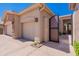 Stone accents with a three-car garage and private courtyard entry at 12770 N 145Th Way, Scottsdale, AZ 85259