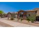 Charming home featuring a stone facade, desert landscaping, and a well-manicured yard at 12770 N 145Th Way, Scottsdale, AZ 85259