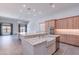 Modern kitchen with stainless appliances, farmhouse sink, large island, and open floorplan at 12770 N 145Th Way, Scottsdale, AZ 85259