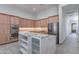Spacious kitchen with double oven, light wooden cabinets, white island and stainless appliances at 12770 N 145Th Way, Scottsdale, AZ 85259