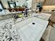 This kitchen features a farmhouse sink, stainless steel faucet, granite countertops and views from the breakfast bar at 12770 N 145Th Way, Scottsdale, AZ 85259