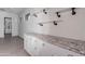 Bright laundry room with granite countertops, custom cabinets, and stylish pipe shelving at 12770 N 145Th Way, Scottsdale, AZ 85259