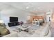 Spacious living room with a ceiling fan, neutral furniture, and an open floor plan that transitions to the kitchen at 12770 N 145Th Way, Scottsdale, AZ 85259