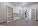 Bright office with a ceiling fan, custom built-ins, and open doorway to another room at 12770 N 145Th Way, Scottsdale, AZ 85259