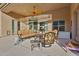 Inviting covered patio with comfortable seating, ceiling fan, and views of the outdoor landscape at 12770 N 145Th Way, Scottsdale, AZ 85259