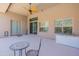Covered patio with tiled floors, ceiling fan, and views of the backyard and desert landscape at 12770 N 145Th Way, Scottsdale, AZ 85259