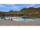 Backyard pool offering stunning mountain views and surrounded by desert landscaping at 12770 N 145Th Way, Scottsdale, AZ 85259