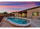 Backyard with a sparkling pool, brick trim, outdoor seating, and manicured landscaping, perfect for leisure at 12770 N 145Th Way, Scottsdale, AZ 85259