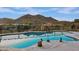 Sparkling pool surrounded by desert landscape and showcasing amazing mountain views in the background at 12770 N 145Th Way, Scottsdale, AZ 85259