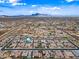 Wide aerial view of a neighborhood with mountains in the background, plus a map pin indicating a specific home at 1319 N Chatsworth St, Mesa, AZ 85207