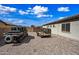 Spacious backyard featuring gravel landscaping, utility vehicle, and trailer, perfect for outdoor activities and storage at 1319 N Chatsworth St, Mesa, AZ 85207