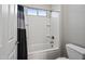 Clean bathroom featuring a shower-tub with white tile surround and a coordinating shower curtain at 1319 N Chatsworth St, Mesa, AZ 85207