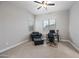 Versatile bedroom setup with a comfortable chair, desk, and large windows for natural light at 1319 N Chatsworth St, Mesa, AZ 85207