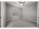 Neutral bedroom with carpet, window, and ceiling fan offers a serene and comfortable space at 1319 N Chatsworth St, Mesa, AZ 85207