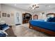 Bright bedroom with a queen bed, entertainment center and ceiling fan at 1319 N Chatsworth St, Mesa, AZ 85207