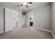Carpeted bedroom with open doorways to a walk-in closet and bathroom at 1319 N Chatsworth St, Mesa, AZ 85207